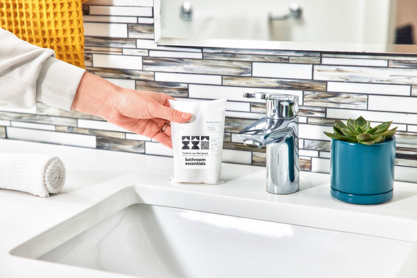 Bathroom essentials pack placed beside a bathroom sink