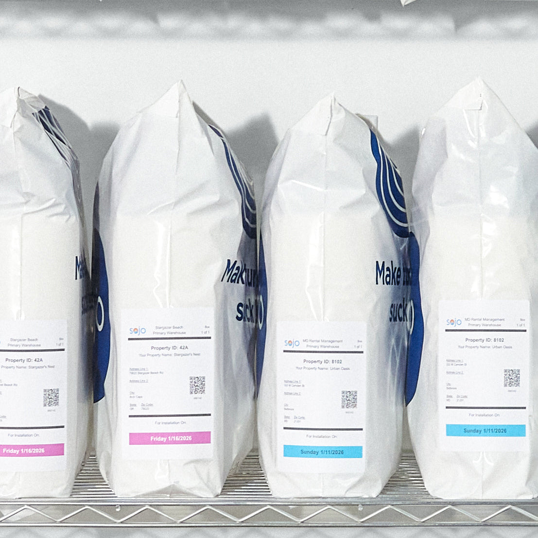 sojo color-coded labeled turn day kit bags with installation dates, organized on metal shelf