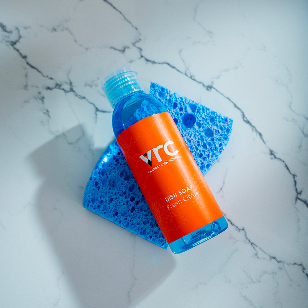 VRC's vacation rental amenities, custom branded mini bottle of dish soap on a blue sponge on the kitchen counter at 