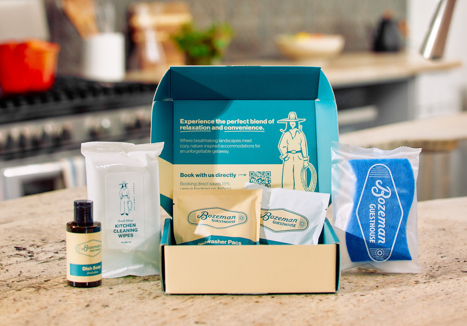 Bozeman Guesthouse welcome kit with dish soap, kitchen wipes, dishwasher pacs, and scrubber on kitchen counter
