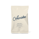 sojo's awake coffee blend, 2.5oz bag in cream color with the word awake" written in cursive in navy blue.