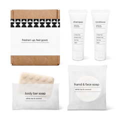 Bathroom essentials kit with shampoo, conditioner, body bar soap, and hand and face soap in a bag.