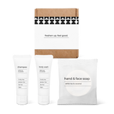 Full bath amenity essentials kit featuring shampoo, body wash, and hand and face soap in a box.
