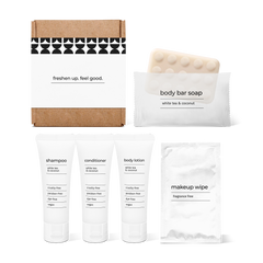 Bathroom amenities kit including shampoo, conditioner, body lotion, body bar soap, and makeup wipe in a box.