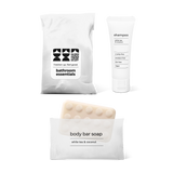 Lite bathroom essentials kit with shampoo and body bar soap in a bag.