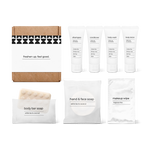Bathroom amenities kit including shampoo, conditioner, body wash, body lotion, body bar soap, hand and face soap, and makeup wipe in a box.