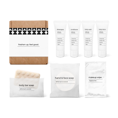 Bathroom amenities kit including shampoo, conditioner, body wash, body lotion, body bar soap, hand and face soap, and makeup wipe in a box.