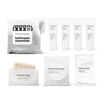 Bathroom amenities kit including shampoo, conditioner, body wash, body lotion, bar soap, hand and face soap, and makeup wipe in a bag.