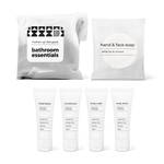 Bathroom essentials kit with shampoo, conditioner, body wash, body lotion, hand and face soap in a bag.