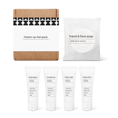 Bathroom essentials kit with shampoo, conditioner, body wash, body lotion, hand and face soap in a box.