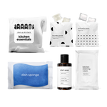 kitchen essentials kit including fresh citrus-scented dish soap, dish sponge, laundry pods, dishwasher pacs, and kitchen cleaning wipes in a bag.