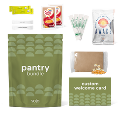 Collection of sojo products including a green 'pantry bundle' package, coffee mate packets, and a 'Awake' coffee bag on a white background.